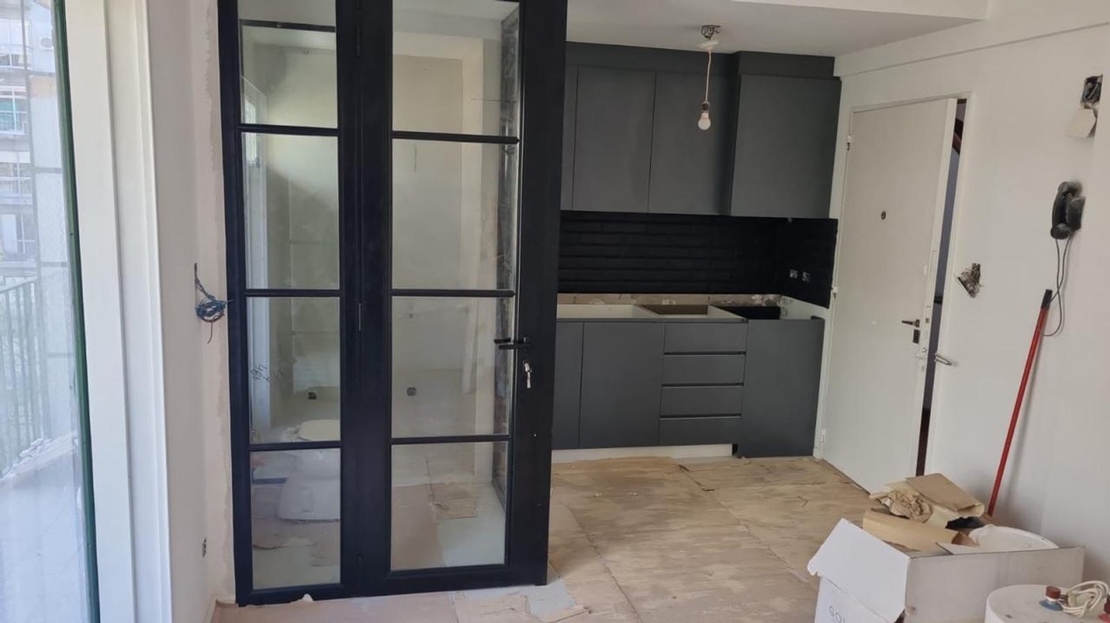 Cocina moderna con gabinetes de madera oscura y puertas de vidrio — proyecto Chenaut, por Estudio NET Arquitectura , en Av. Gral. Indalecio Chenaut